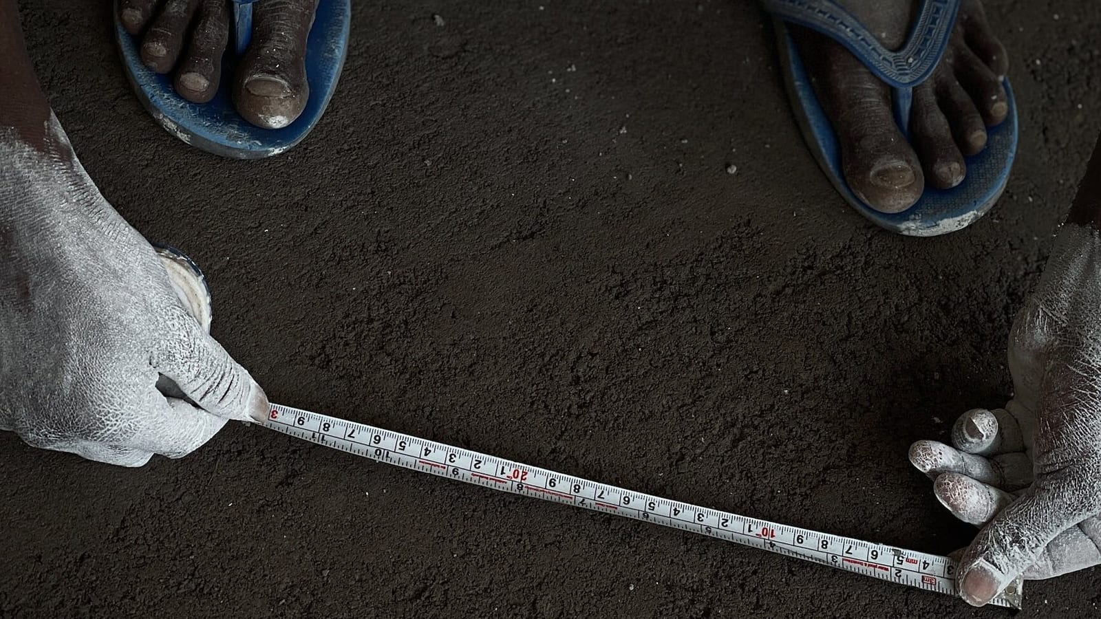 person using measure on soil